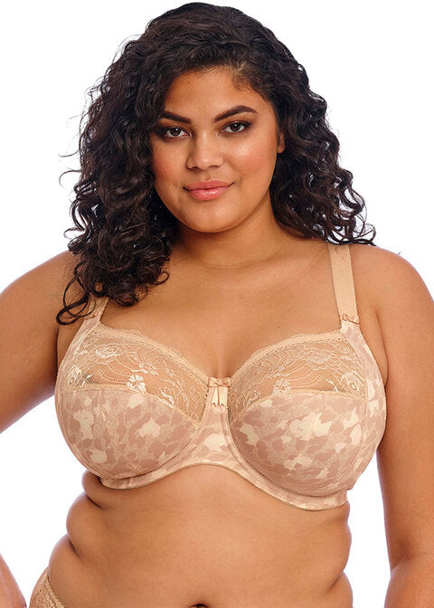 curvy woman wearing a big cup bra in beige with subtile leaves print and stretch lace