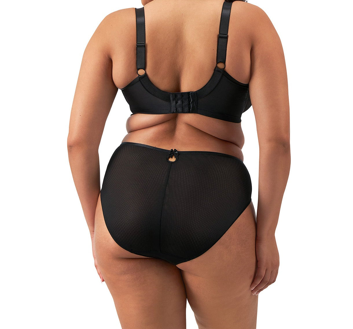 curvy woman wearing a plussize highwaist highleg brief in black mesh with flower details in almond