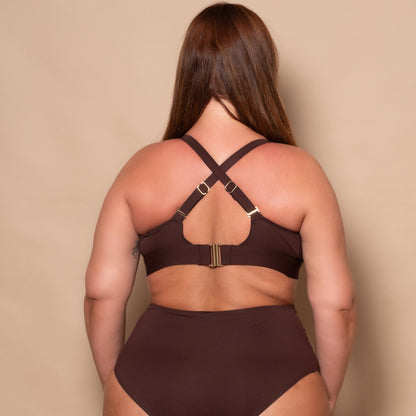 plussize woman wearing a chocolate brown bikini set against a beige background