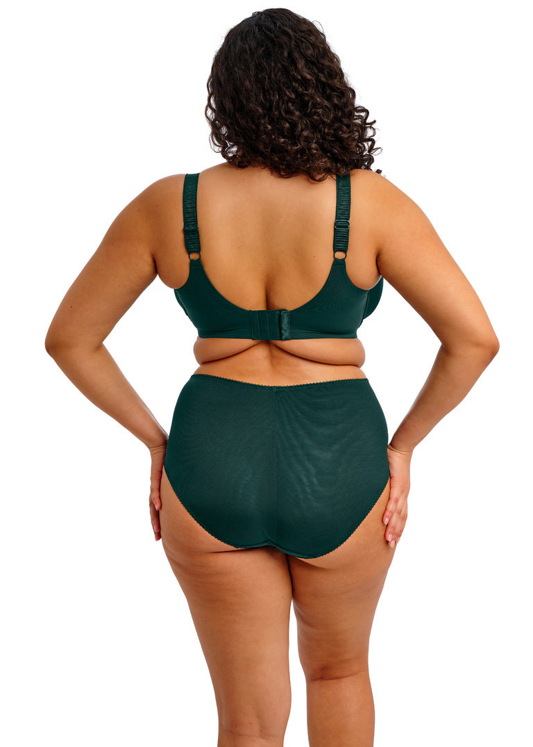 curvy woman wearing a deep emerald satin bra with lace details and matching brief