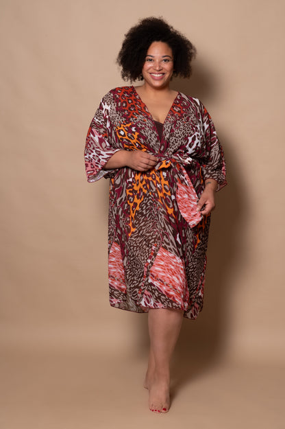 Woman wearing a patterned dress against a beige background
