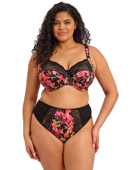 curvy woman wearing a plussize bra in black with colourfull printed flowers and stretch lace  and matching briefs