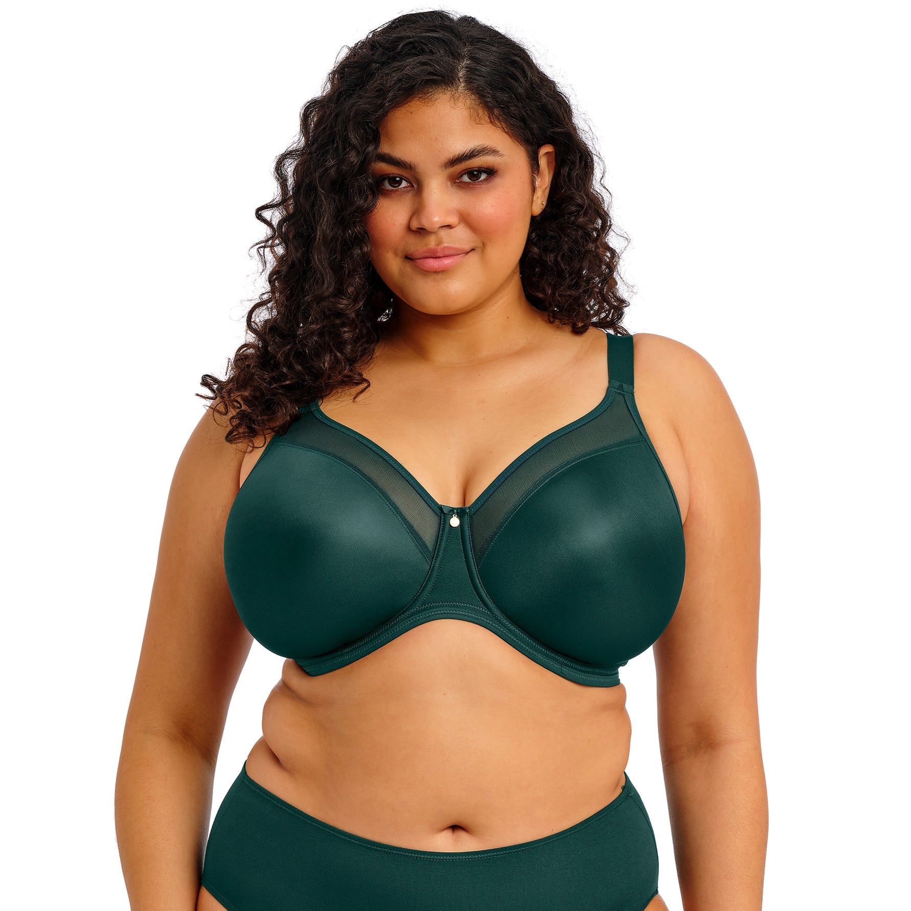 curvy woman wearing an emerald green lingerie set against a white background
