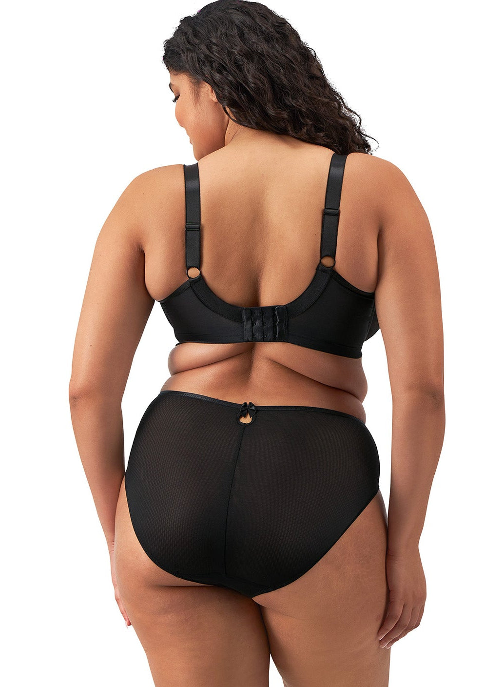 curvy woman wearing a black big cup  bra with lace and embroidered flowers in almond colour
