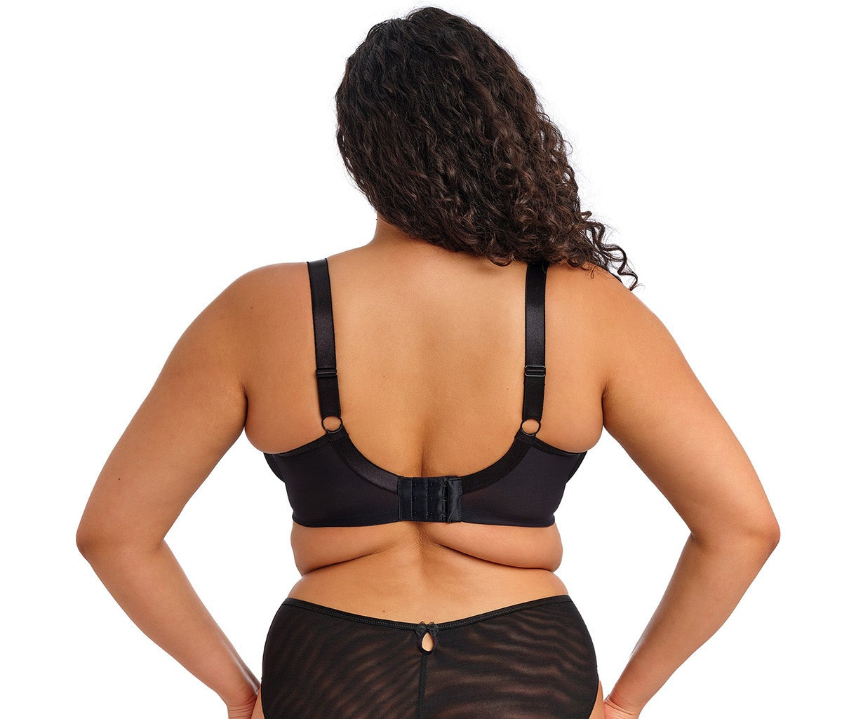 curvy woman wearing a black big cup bra with lace and embroidered flowers in summer colours