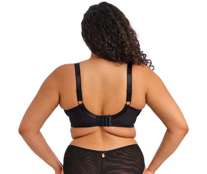 curvy woman wearing a black big cup bra with lace and embroidered flowers in summer colours