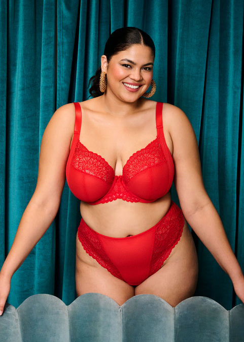 curvy woman wearing Red lingerie with lace details on a white background