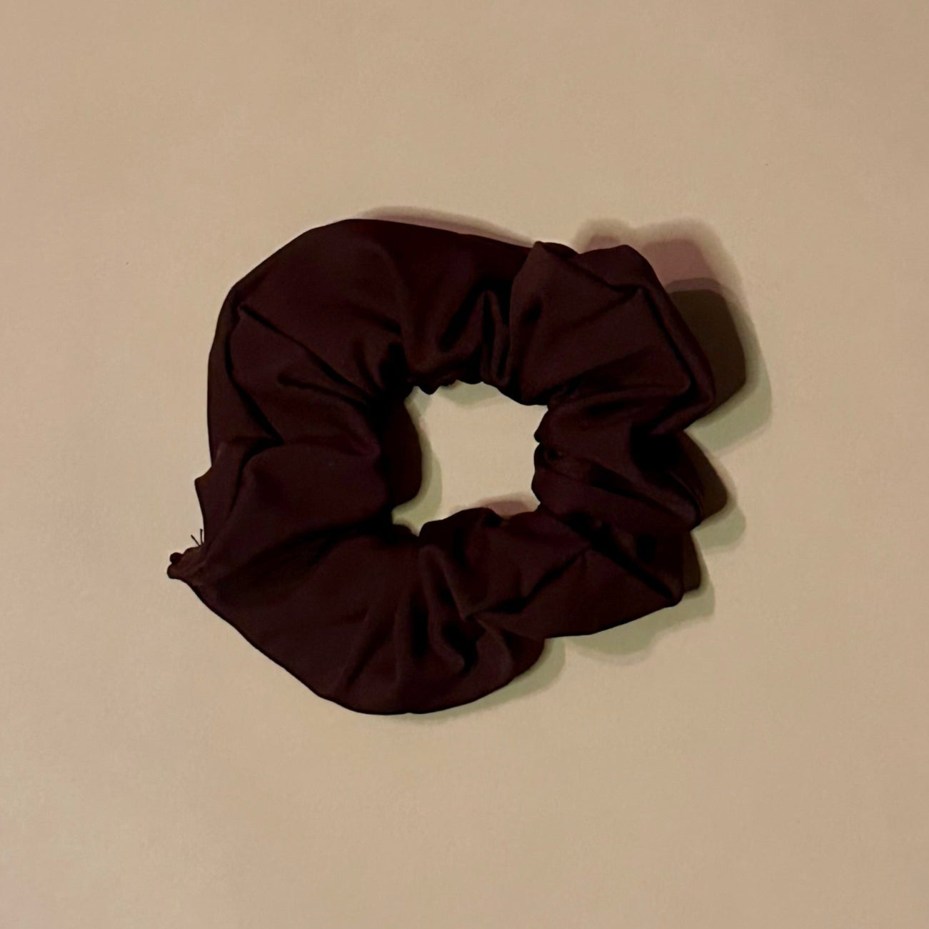 Brown scrunchie on a beige background
