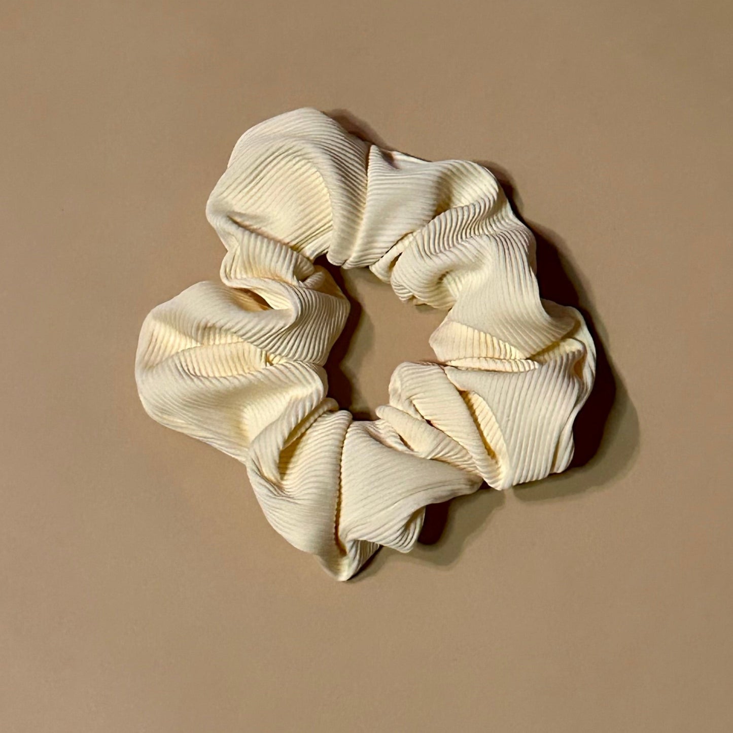cream white ribbed scrunchie on a beige background