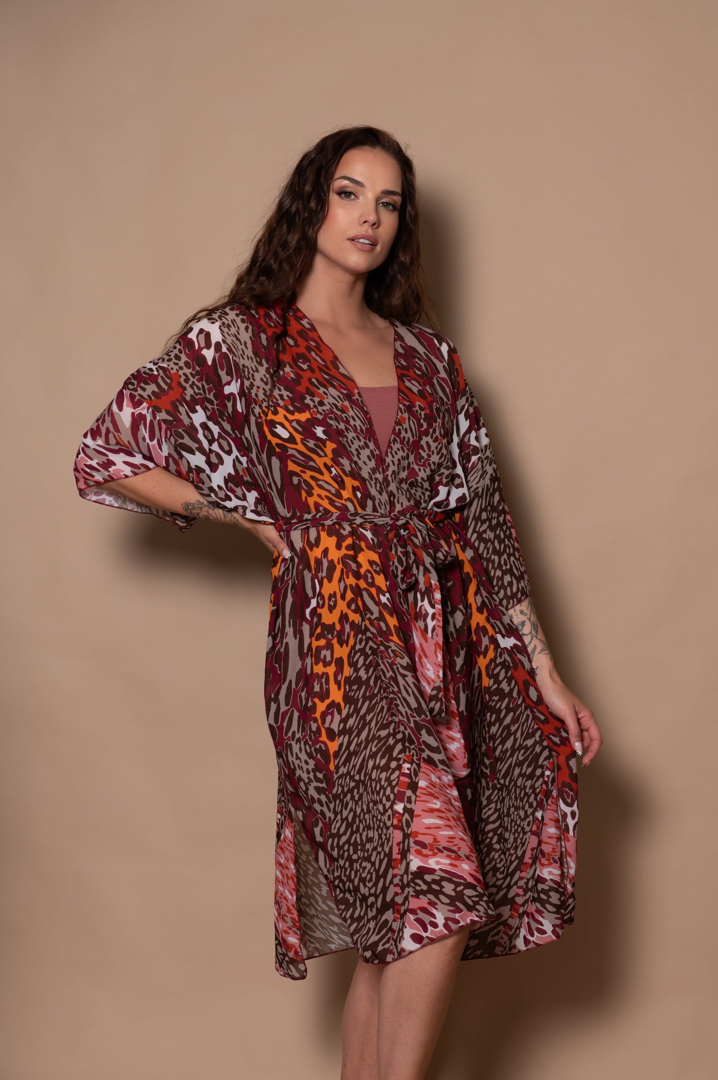 Woman wearing a patterned dress against a beige background