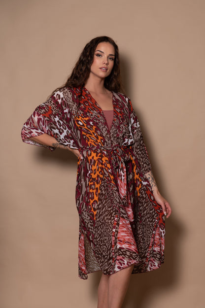 Woman wearing a patterned dress against a beige background
