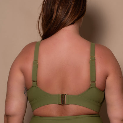 plussize woman wearing a khaki green bikini  against a beige background
