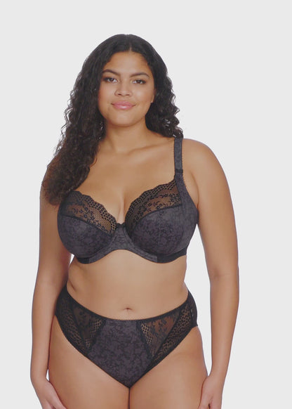 curvy Woman wearing a black lace lingerie set on a white background