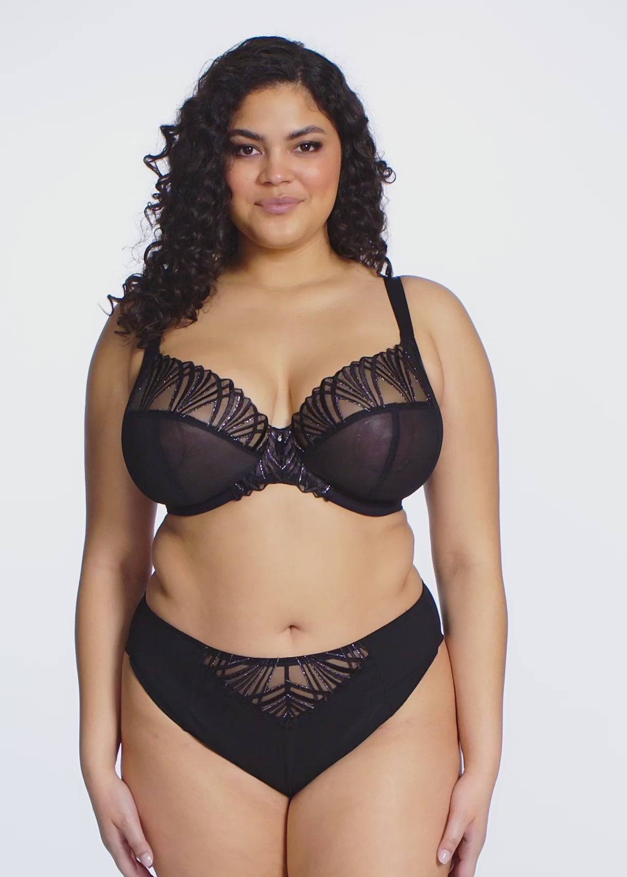 Black lingerie set with lace detailing on a white background
